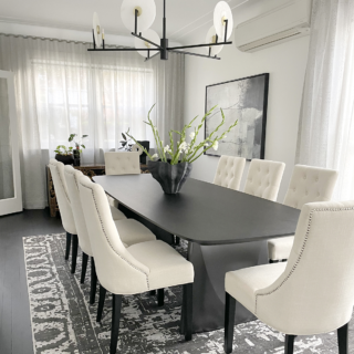 Dining Chairs around dark wooden dining table with exquisite pendant and rug