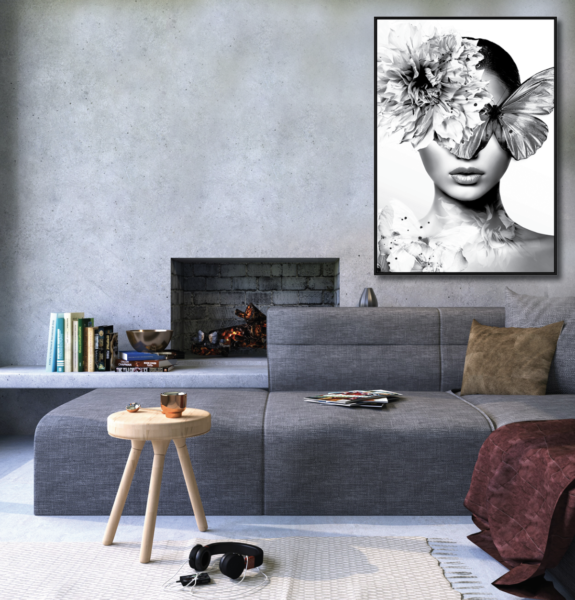 Black and white artwork hanging on a large wall next to a fire place behind a modular sofa